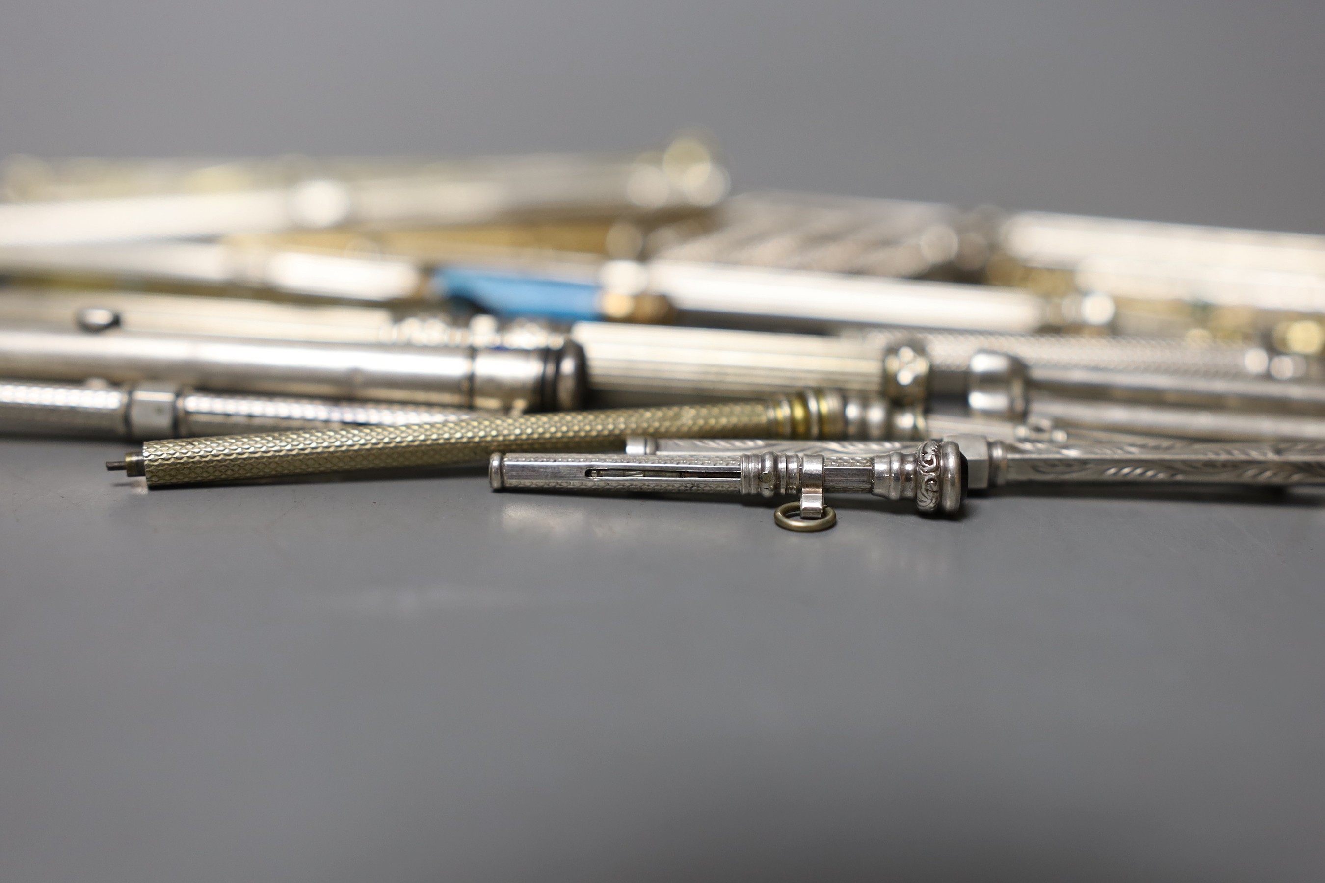 A collection of assorted white and base metal propelling pencils, etc.